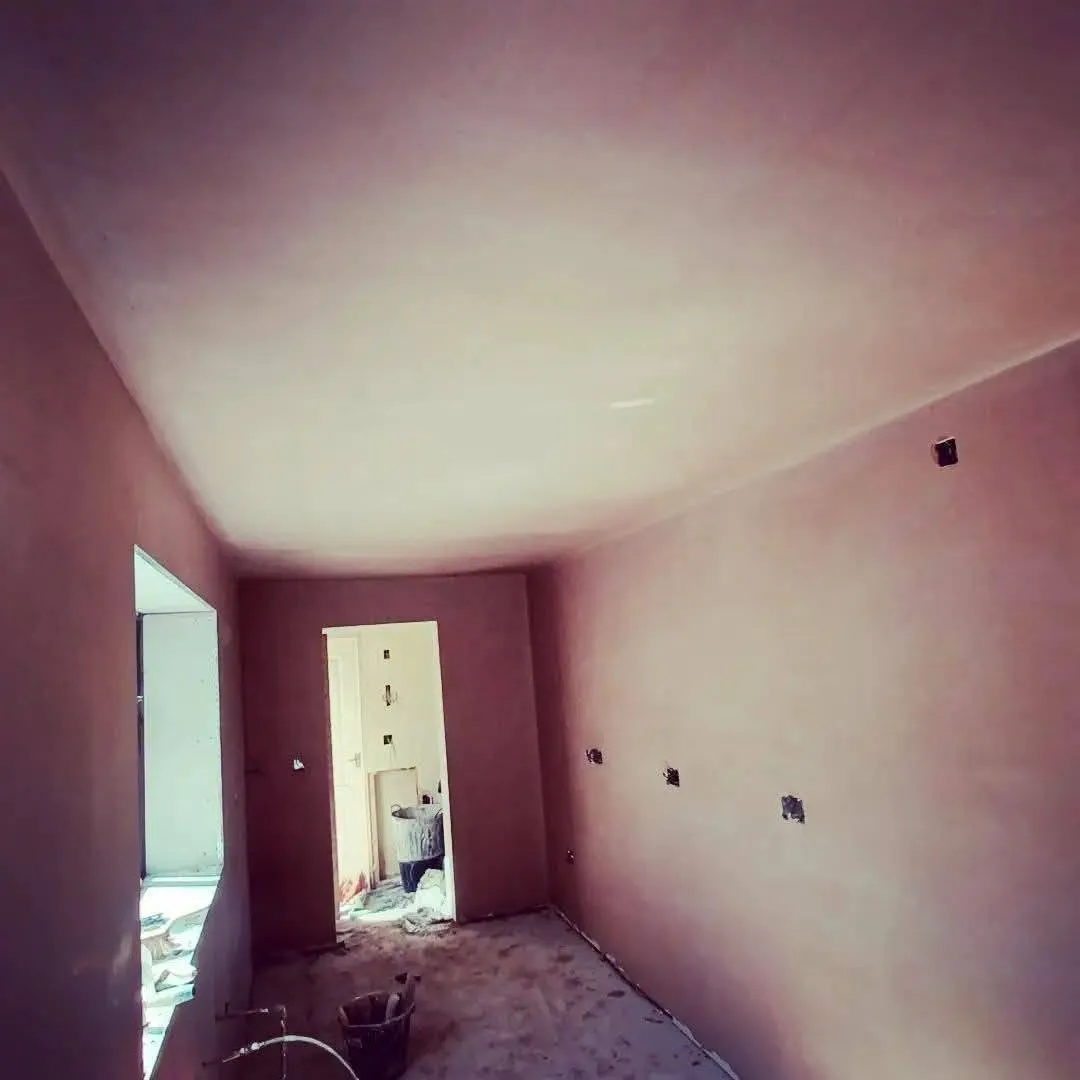 Newly skimmed walls and ceiling drying in an empty room